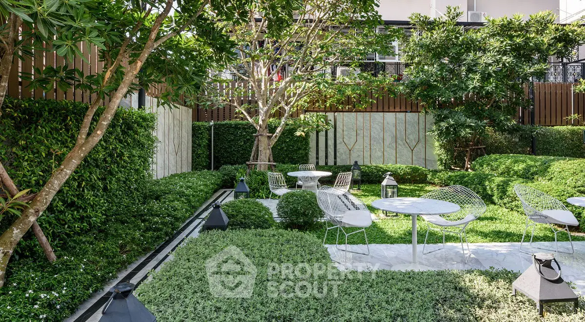 Lush garden with modern outdoor seating and greenery