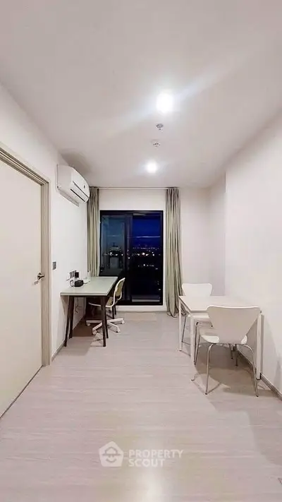 Modern study room with city view, featuring sleek furniture and ample natural light.
