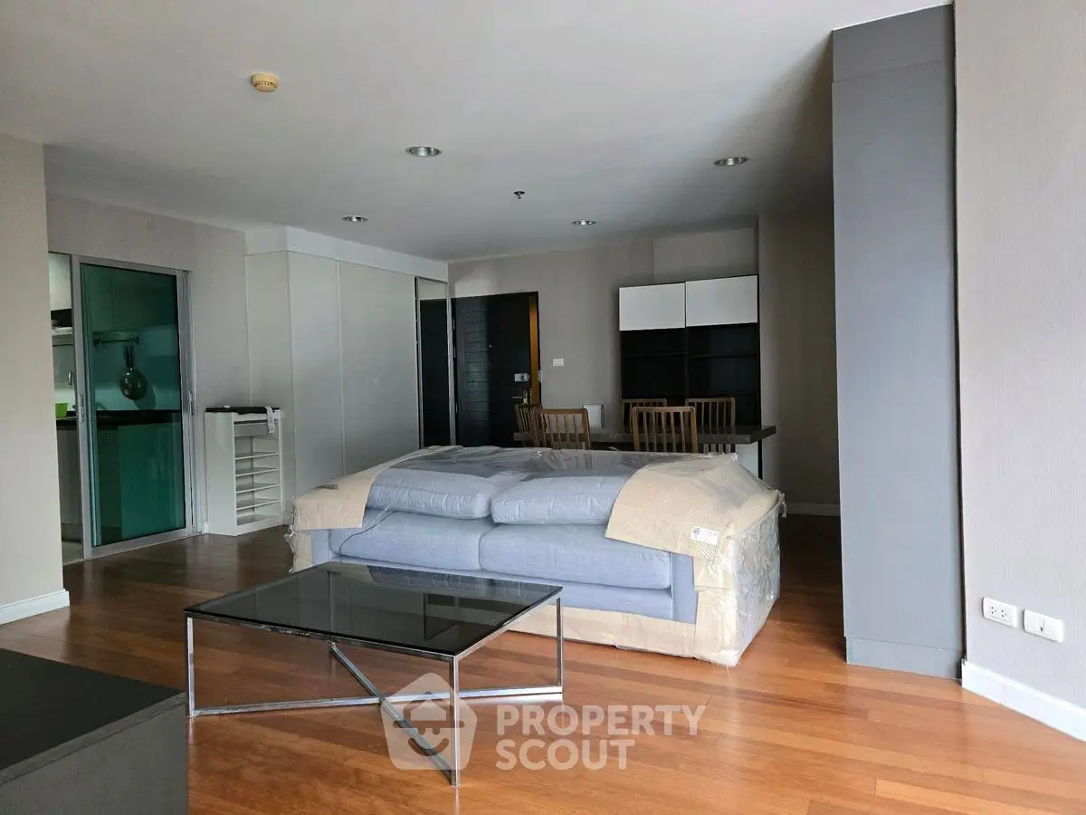 Spacious modern living room with hardwood floors and contemporary furniture