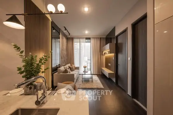 Modern living room with open kitchen, stylish decor, and natural lighting
