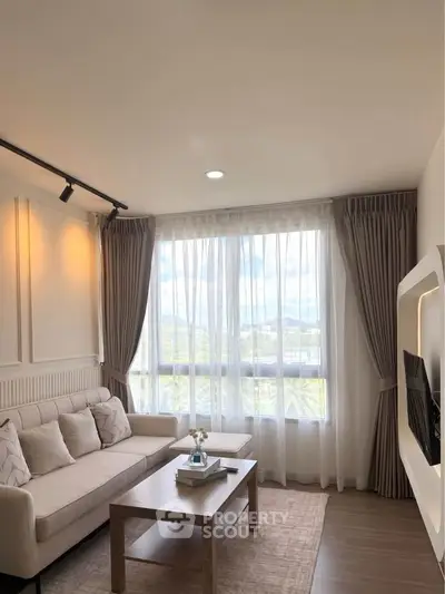 Elegant living room with large window and cozy seating area