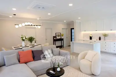 Luxurious open-plan living room with modern decor and elegant dining area