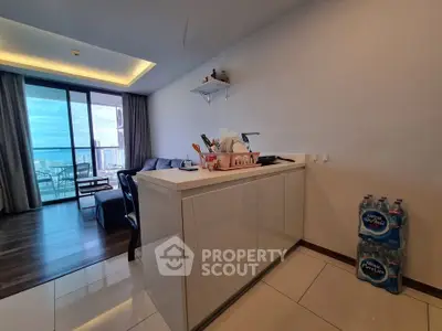 Modern apartment with open layout and stunning ocean view balcony.