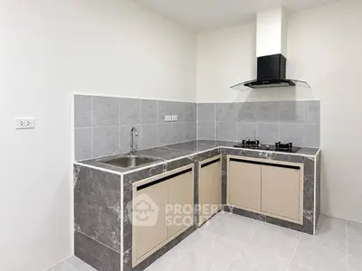 Modern kitchen with sleek design, featuring gas stove and ample counter space.