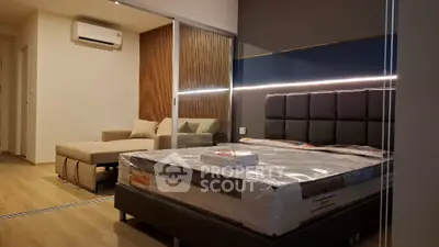 Modern bedroom with stylish lighting and comfortable seating area