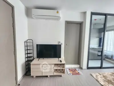 Modern living room with air conditioning and sleek TV stand in a stylish apartment.