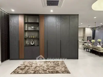 Modern living room with sleek cabinetry and open kitchen layout