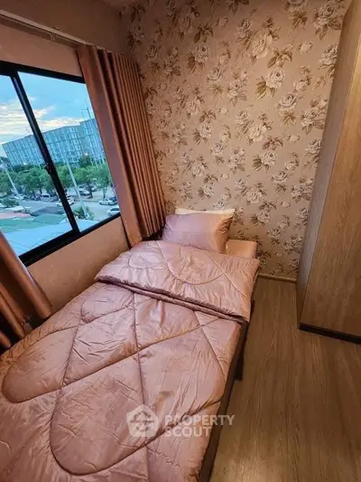 Cozy bedroom with floral wallpaper and city view, perfect for relaxation and comfort.