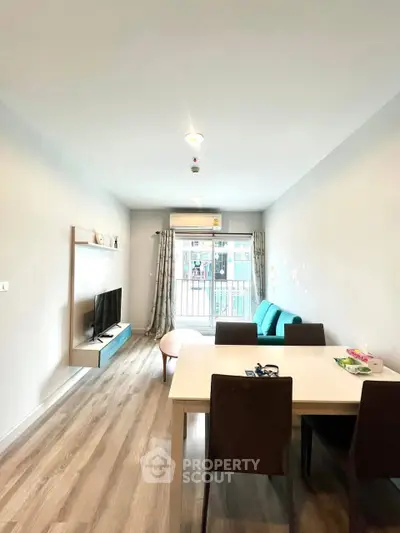 Modern living room with sleek furniture and balcony view