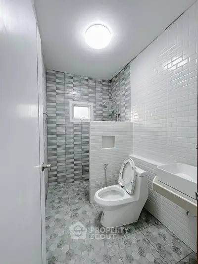 Modern bathroom with sleek tiles and contemporary fixtures.