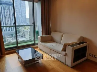 Modern living room with city view, featuring a cozy sofa and sleek coffee table, perfect for urban living.