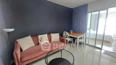 Modern living room with stylish sofa and dining area in open-plan apartment.