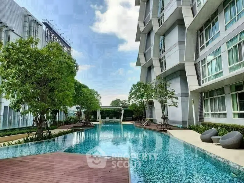 Luxurious modern apartment complex with stunning pool and lush greenery