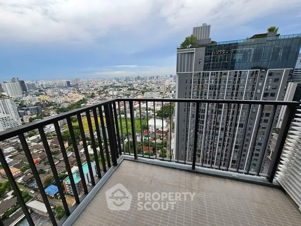 Stunning high-rise balcony view overlooking cityscape with modern architecture and lush greenery.