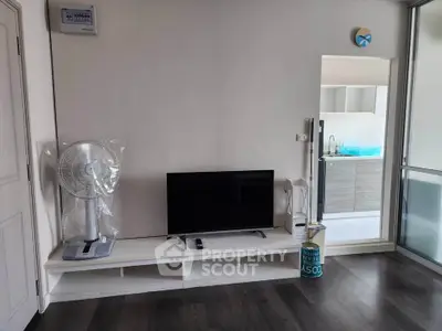 Modern living room with sleek TV stand and open kitchen view