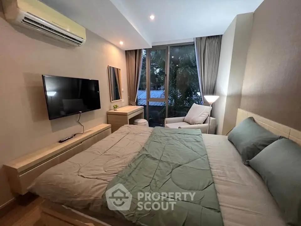 Cozy bedroom with modern decor, large window, and stylish furnishings in a serene setting.