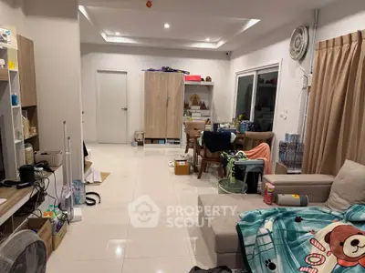 Spacious living room with modern decor and ample natural light.