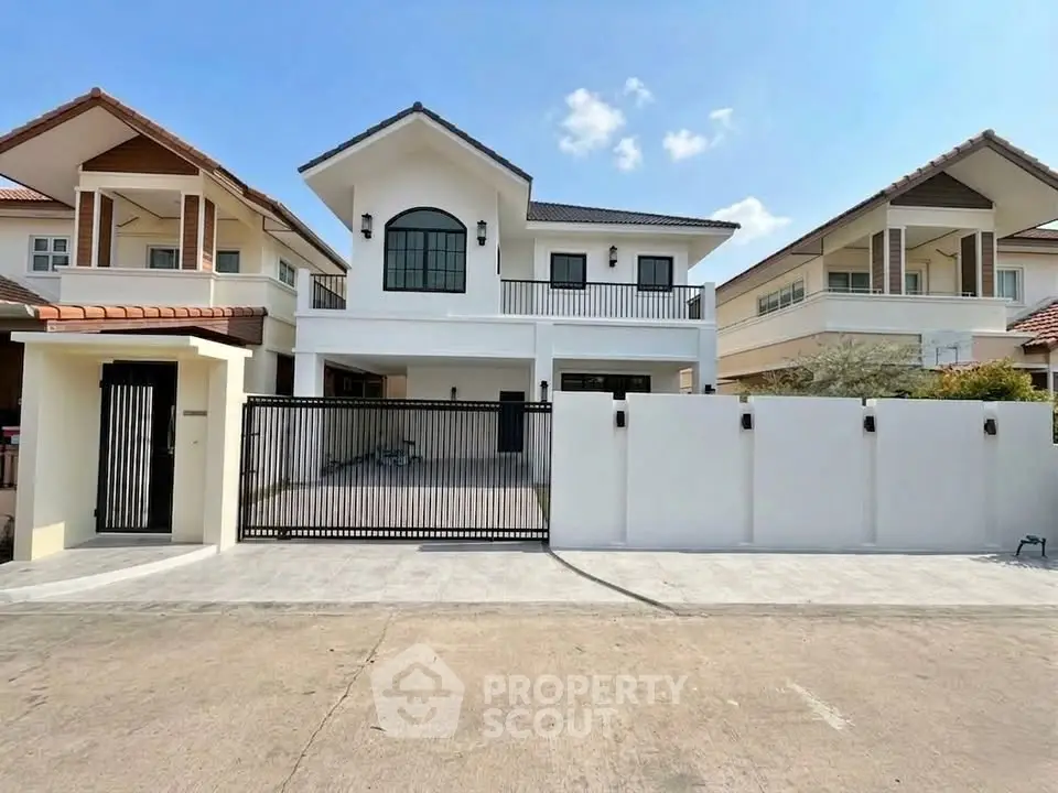 Stunning modern house with gated entrance and spacious driveway in a serene neighborhood.