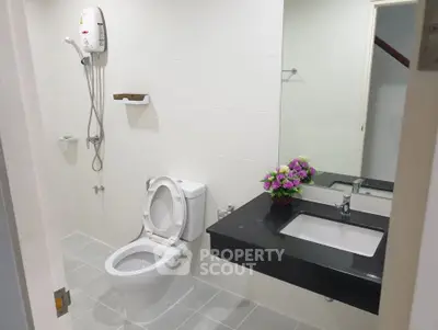 Modern bathroom with sleek fixtures and elegant black countertop