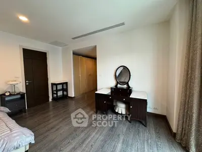 Spacious bedroom with elegant wooden furniture and ample natural light