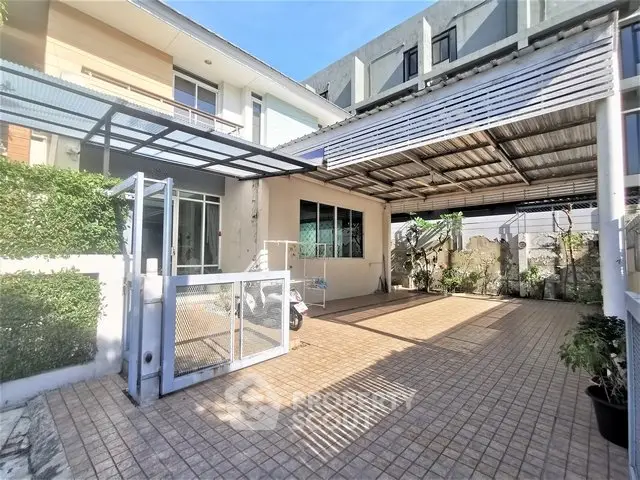 Spacious modern home exterior with covered parking and lush greenery
