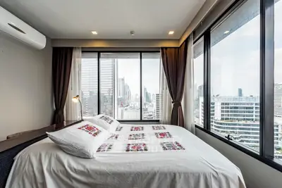 Modern bedroom with panoramic city view and stylish decor