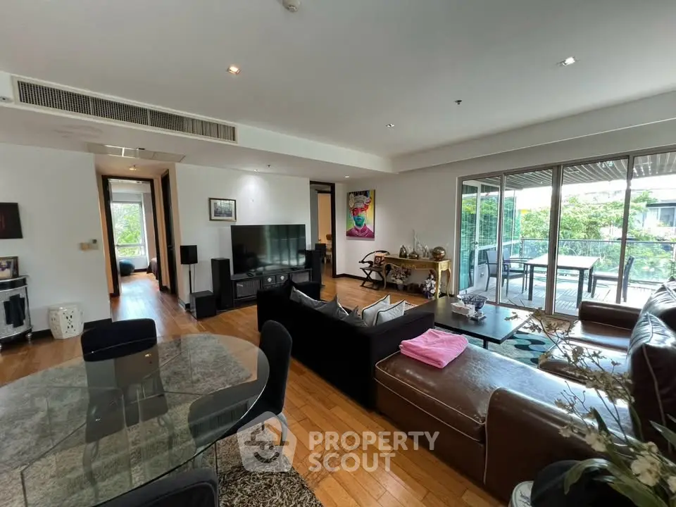Spacious living room with modern decor and large balcony view