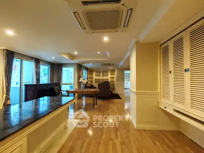 Spacious living room with hardwood floors and elegant furnishings