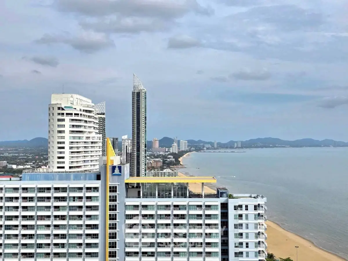 Stunning beachfront high-rise buildings with panoramic ocean views and sandy beaches, perfect for luxury living.