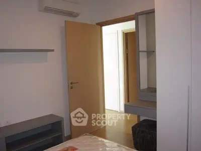 Modern bedroom with minimalist design and built-in storage solutions.