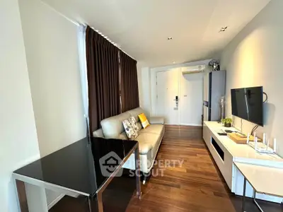 Modern living room with sleek furniture and hardwood floors in a stylish apartment.