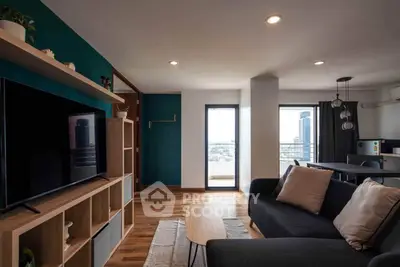 Modern living room with stylish decor and city view balcony in a contemporary apartment.