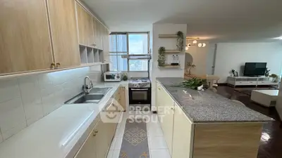 Spacious kitchen with open layout and modern appliances in a bright apartment.