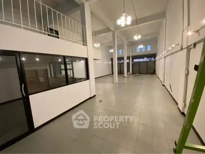 Spacious commercial property with high ceilings and mezzanine, ideal for retail or office space.