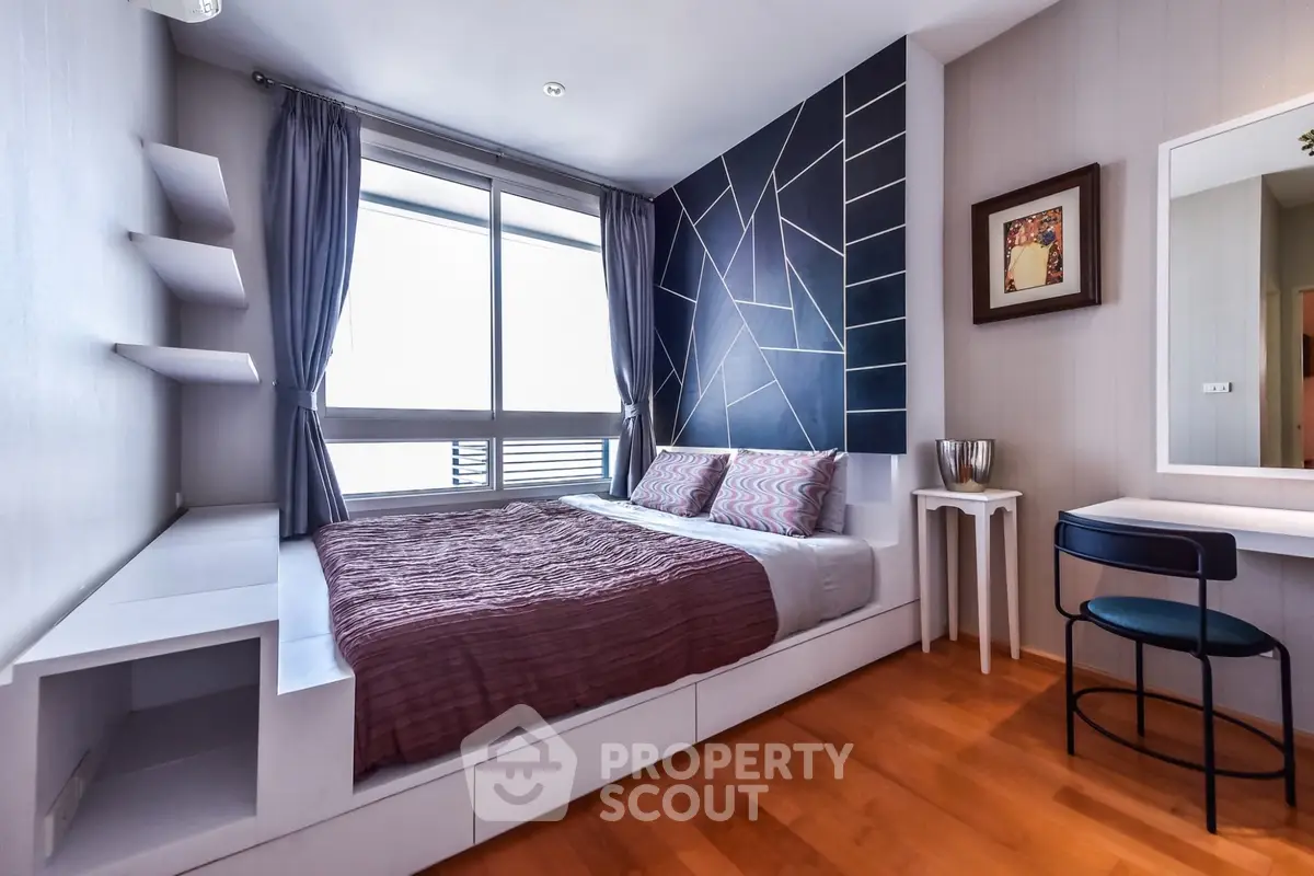 Modern bedroom with stylish geometric accent wall and large window