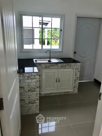 Modern kitchen with sleek countertops and stylish cabinetry, perfect for culinary enthusiasts.