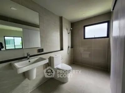 Modern bathroom with sleek fixtures and large window for natural light.