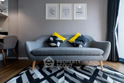 Stylish modern living room with chic grey sofa and geometric rug