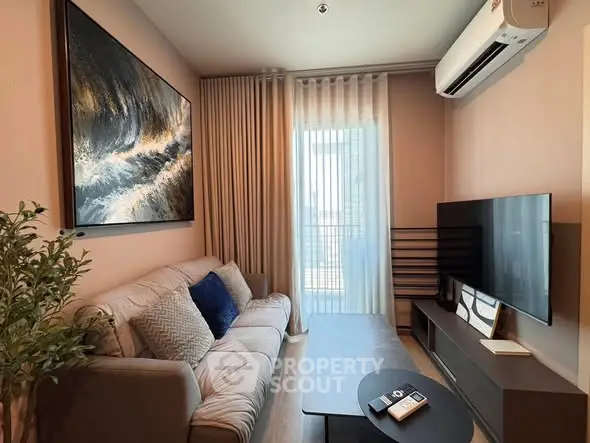 Cozy living room with modern decor, featuring a comfortable sofa, large TV, and stylish artwork.