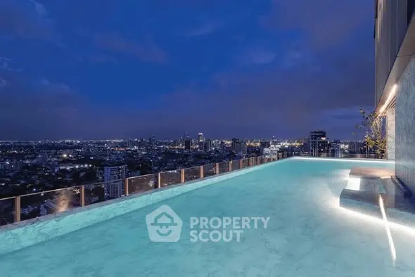 Luxurious rooftop infinity pool with stunning city skyline view at night.