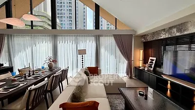 Luxurious modern living room with high ceilings and large windows offering stunning city views.