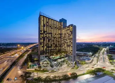 Stunning high-rise building with panoramic city views at sunset, perfect for urban living.
