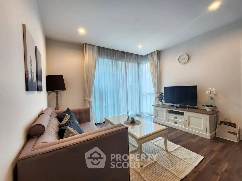 Charming living room with cozy sofa, elegant decor, and large windows for natural light.