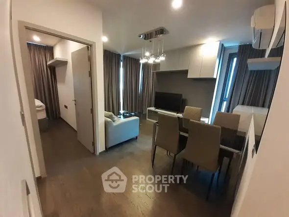 Modern living room with dining area and stylish decor in a cozy apartment.