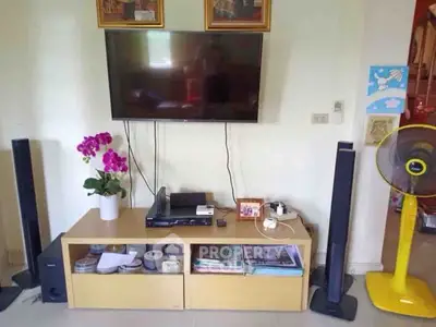 Modern living room with wall-mounted TV and stylish sound system