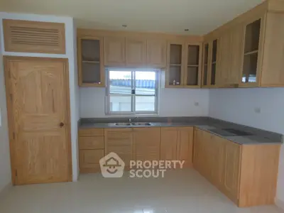 Spacious kitchen with wooden cabinets and modern appliances