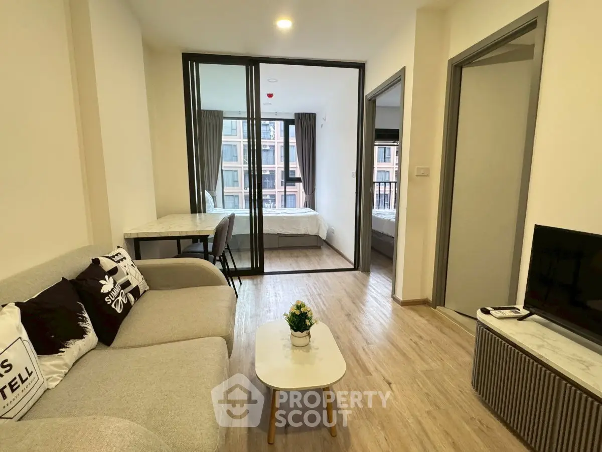 Modern living room with cozy sofa and stylish decor in a contemporary apartment.