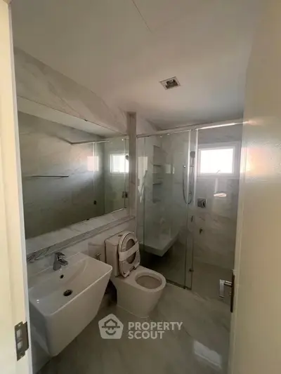 Modern bathroom with glass shower and sleek fixtures