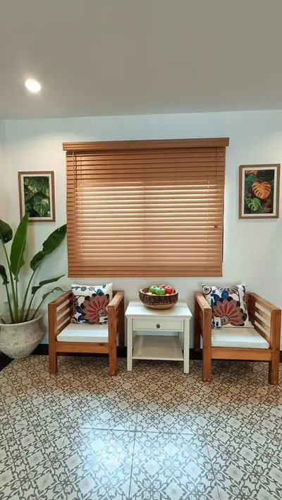 Charming living area with cozy chairs, decorative pillows, and elegant flooring.