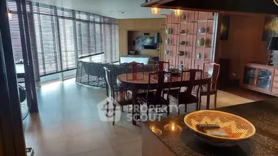 Luxurious open-plan living and dining area with modern decor and large windows.